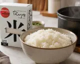 Idealny ryż do sushi, gotowy do przygotowania. Pudełko z napisem "Ryż do sushi" i miska pełna ugotowanego ryżu.