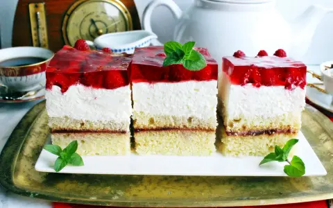 Pyszny biszkopt z serkiem mascarpone i bitą śmietaną, przełożony dżemem, z galaretką truskawkową i malinami.