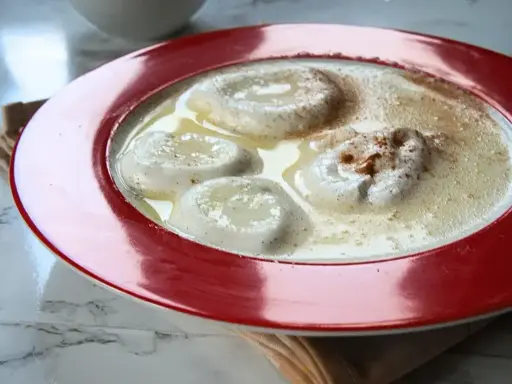 Puszysta zupa nic w czerwonej misce, posypana cynamonem. Idealna na chłodne dni.