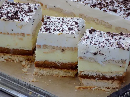 Pyszne ciasto 3 bit prosty przepis. Warstwy biszkoptu, kremu, karmelu i bitej śmietany, posypane czekoladą.