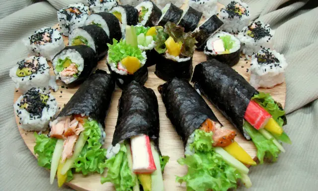 Talerz pełen pyszności: sushi z łososiem, awokado, krabem i warzywami. Idealne na co do sushi.